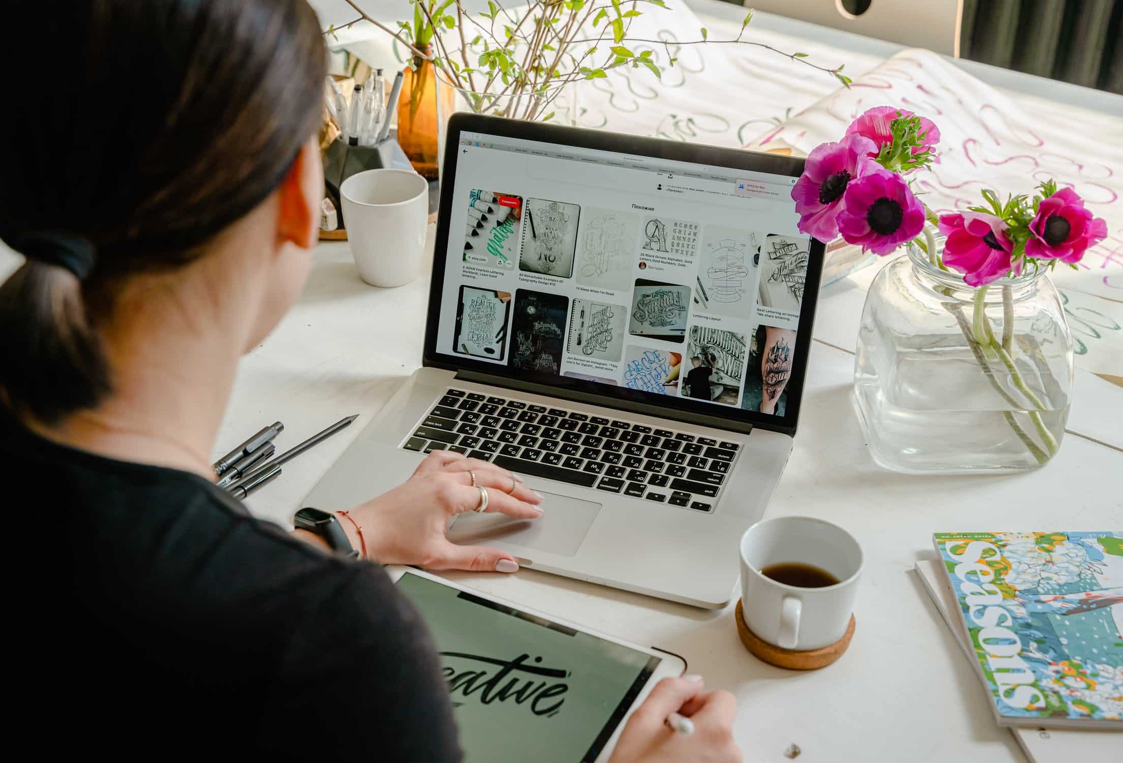 A woman browsing pictures on a laptop.