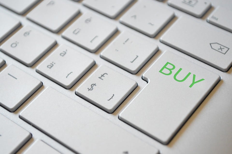 A close-up of a keyboard where the Enter button reads “buy”.