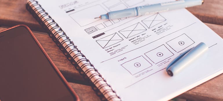 a notebook with a website design plan