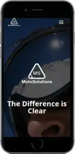 A smartphone screen displays the MotoSolutions website, showing a close-up of a person wearing goggles with a snowy landscape reflected in the lens and the text The Difference is Clear.