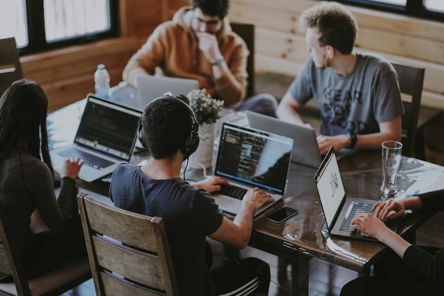 Team of web designers working together on laptops in a cozy office.